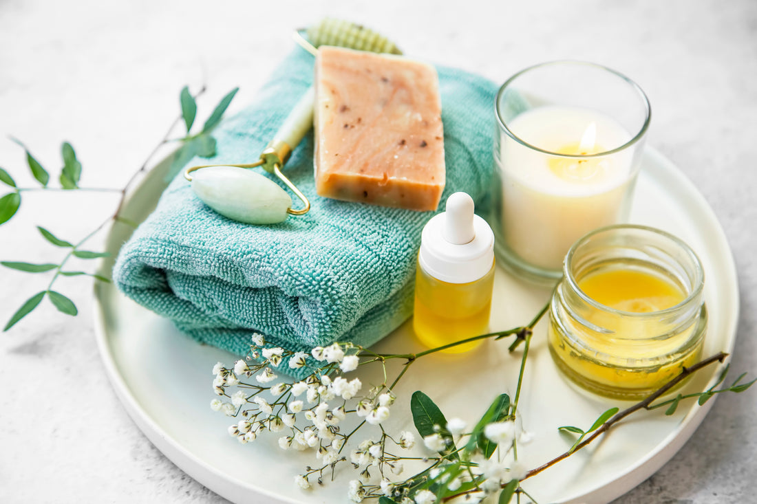 Ilawan Soaps Blog Detoxifying your skincare routine. Image of a natural bar of soap, candle, face oil, and lip balm